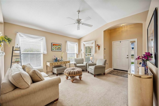 living room featuring ceiling fan, lofted ceiling, and carpet