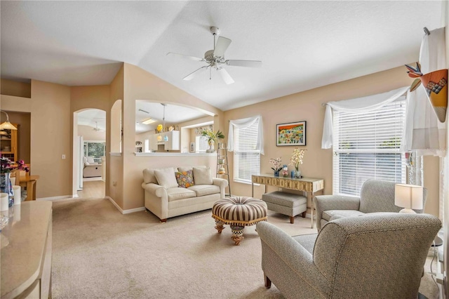 carpeted living room with plenty of natural light, lofted ceiling, and ceiling fan