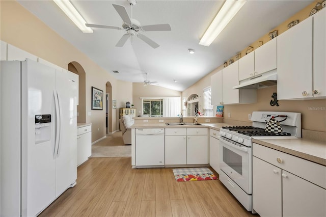 kitchen with lofted ceiling, sink, white appliances, white cabinetry, and light hardwood / wood-style floors