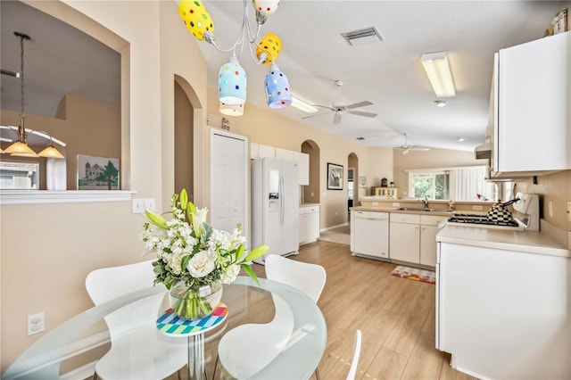 interior space with lofted ceiling, sink, ceiling fan, and light wood-type flooring