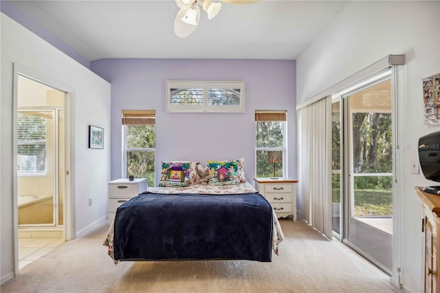 carpeted bedroom featuring ensuite bathroom, access to exterior, and multiple windows