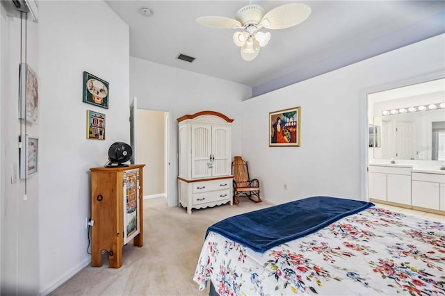 carpeted bedroom with connected bathroom and vaulted ceiling