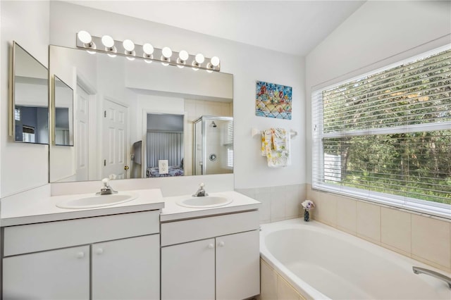 bathroom with vanity and independent shower and bath