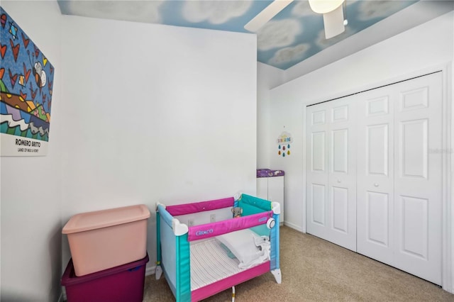 bedroom featuring carpet flooring, ceiling fan, and a closet