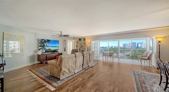 living room with hardwood / wood-style floors and ceiling fan