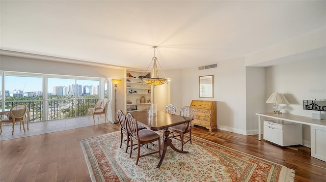 dining area featuring hardwood / wood-style floors and built in shelves