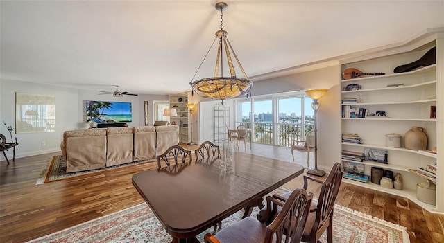 dining space with ceiling fan and wood-type flooring