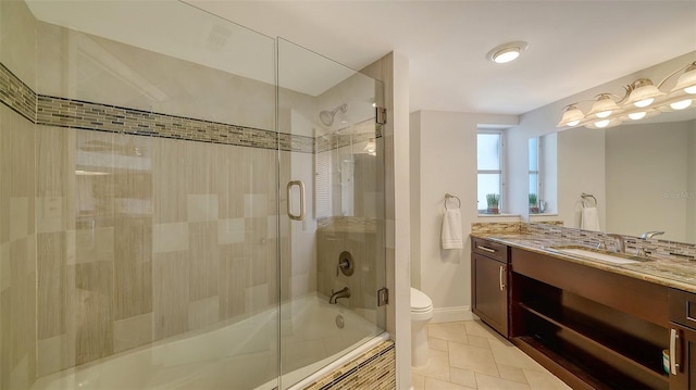 full bathroom featuring enclosed tub / shower combo, vanity, toilet, and tile patterned floors