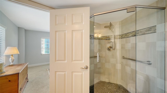 bathroom with a shower with door