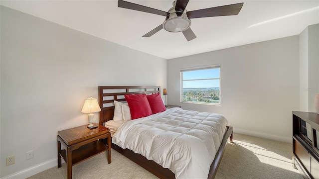 bedroom with ceiling fan and light colored carpet