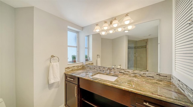 bathroom with tasteful backsplash, vanity, and walk in shower