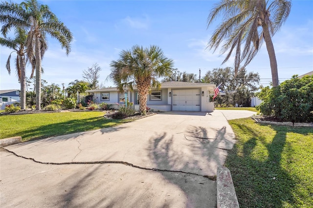 view of front of house with a garage and a front lawn