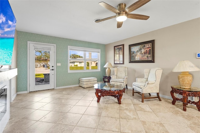 living area with ceiling fan and light tile patterned floors