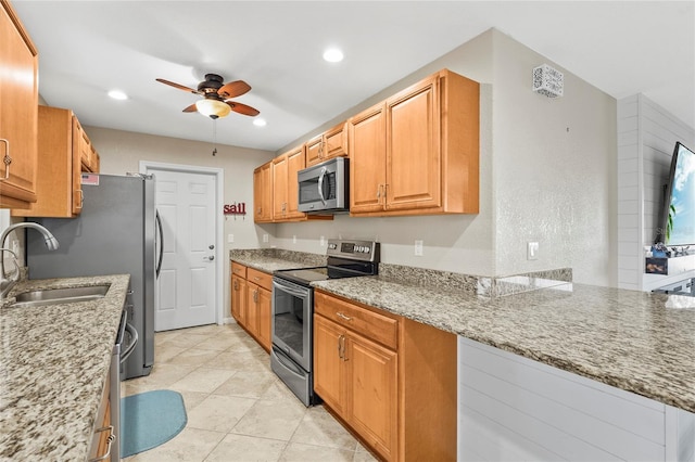 kitchen featuring sink, appliances with stainless steel finishes, light stone countertops, and ceiling fan