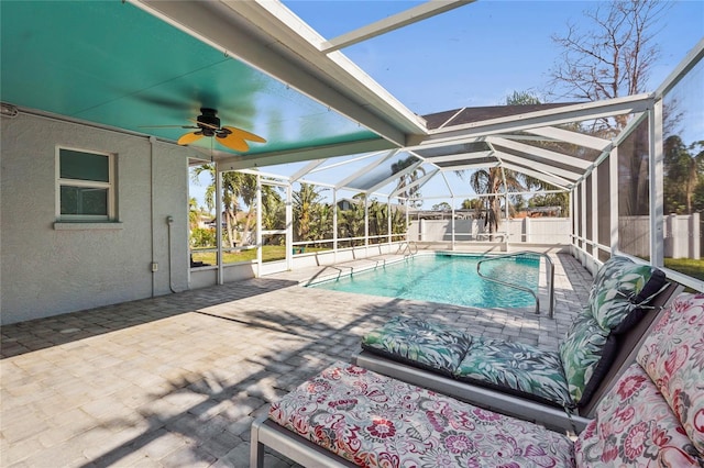 view of swimming pool with a lanai, ceiling fan, and a patio area