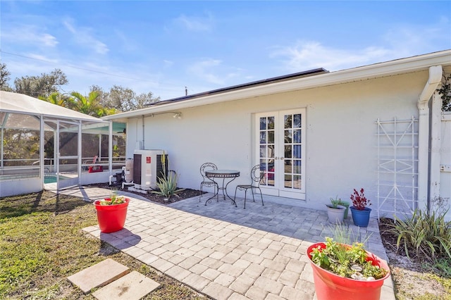 back of property featuring french doors, a patio, and a lanai