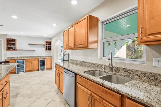 kitchen with open shelves, stainless steel dishwasher, a sink, and beverage cooler