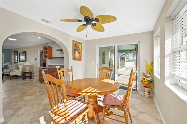 dining room with baseboards, recessed lighting, visible vents, ceiling fan, and arched walkways
