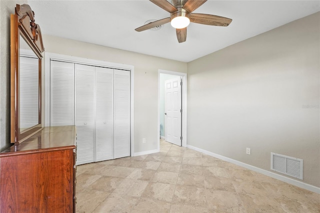 unfurnished bedroom with visible vents, baseboards, a ceiling fan, and a closet