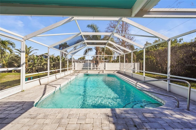 view of pool featuring a fenced in pool, a patio, a fenced backyard, and glass enclosure
