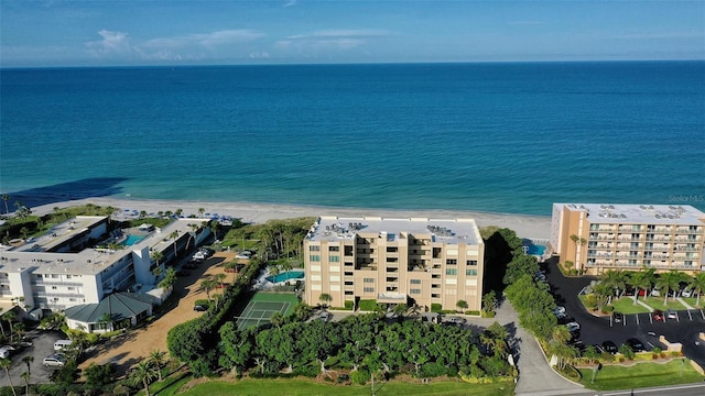 drone / aerial view featuring a water view and a view of the beach