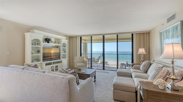 carpeted living room featuring a wall of windows