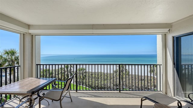 balcony featuring a water view