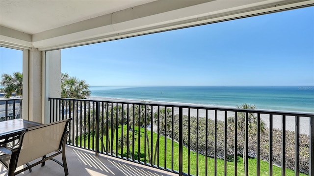 balcony with a water view and a beach view