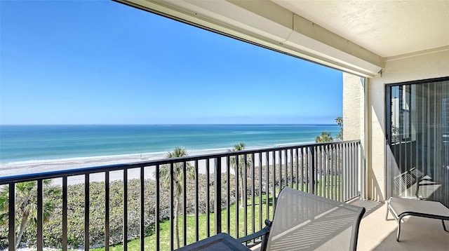 balcony featuring a water view and a view of the beach