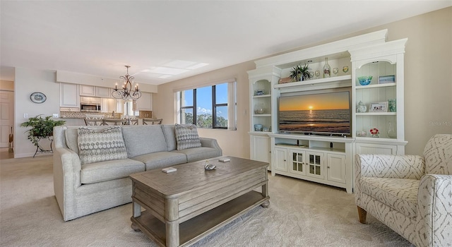 carpeted living room with a notable chandelier