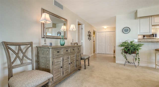 sitting room with light colored carpet