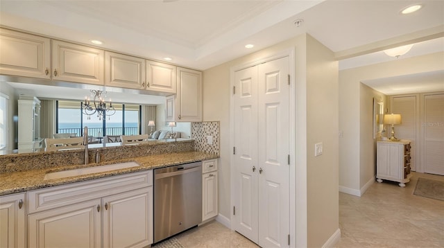 kitchen with tasteful backsplash, sink, stainless steel dishwasher, light stone counters, and a water view