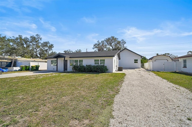 ranch-style home with central AC and a front lawn