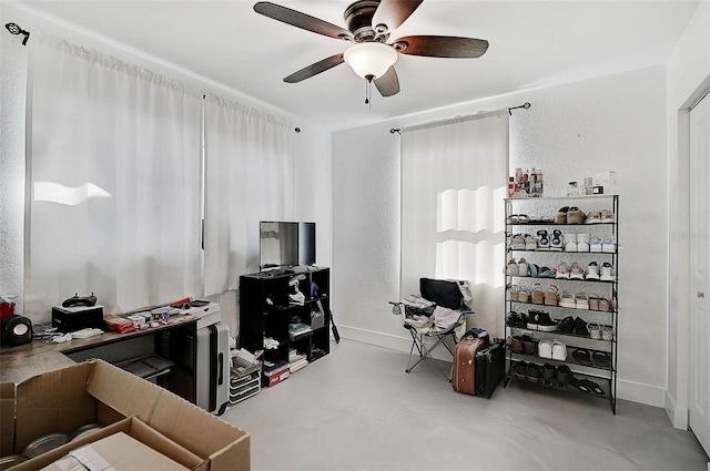 office space featuring ceiling fan and concrete flooring