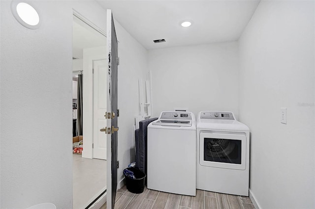 washroom featuring washer and clothes dryer