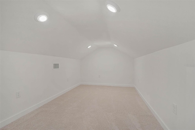 additional living space with light carpet and lofted ceiling