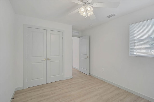 unfurnished bedroom featuring ceiling fan, light hardwood / wood-style flooring, and a closet