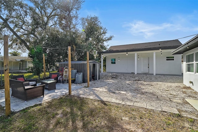 exterior space with a patio, a shed, and an outdoor hangout area