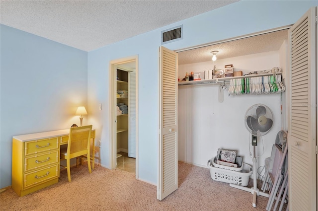 interior space with visible vents, a textured ceiling, and light colored carpet