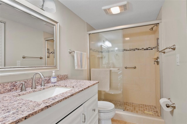 full bathroom with a textured ceiling, toilet, vanity, visible vents, and a stall shower