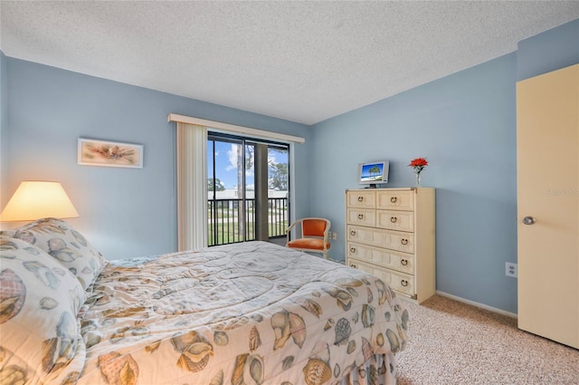 bedroom with access to exterior, a textured ceiling, baseboards, and carpet flooring