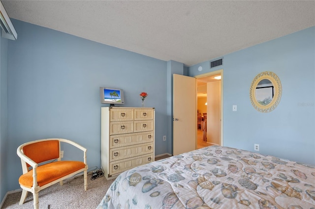 carpeted bedroom featuring visible vents and a textured ceiling