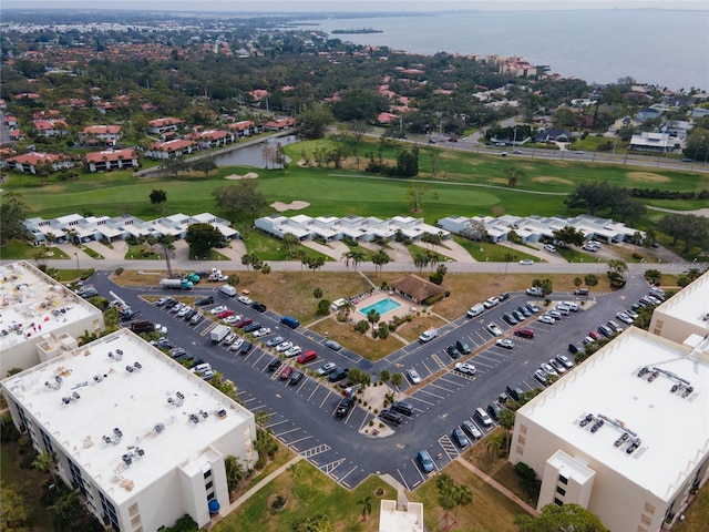 birds eye view of property featuring golf course view and a water view