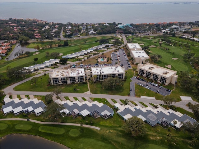 aerial view with golf course view and a water view