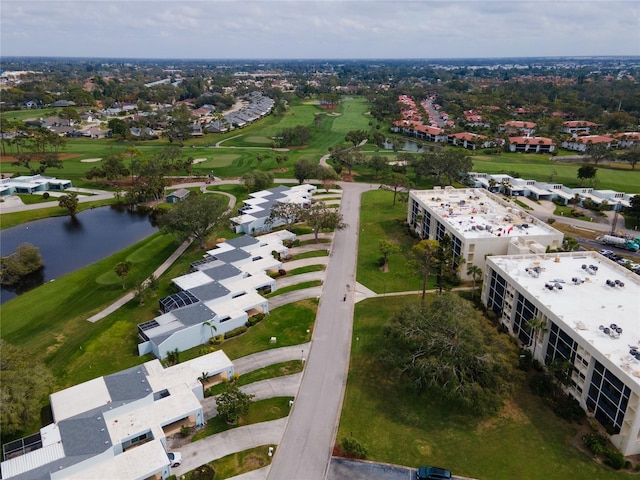 drone / aerial view featuring view of golf course and a water view