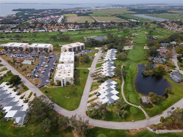 birds eye view of property featuring view of golf course and a water view