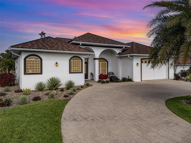 mediterranean / spanish house with a garage