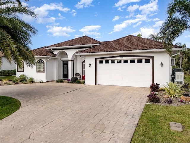 mediterranean / spanish home featuring a garage