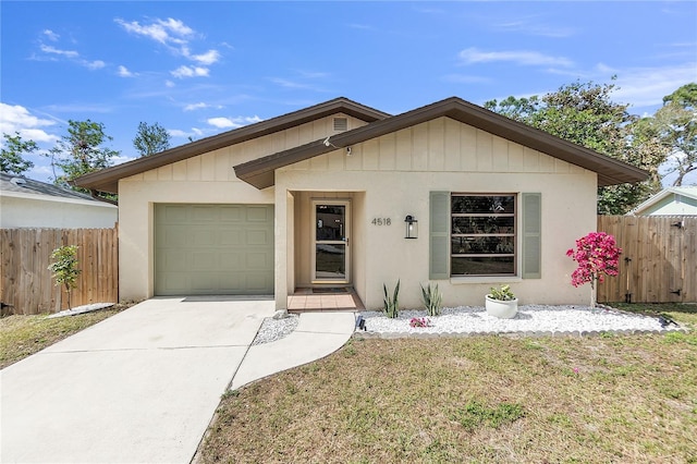 single story home with a garage and a front lawn