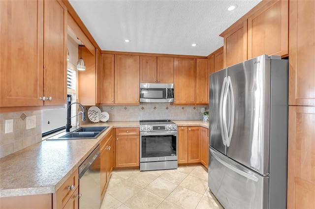 kitchen with pendant lighting, sink, appliances with stainless steel finishes, backsplash, and light tile patterned flooring